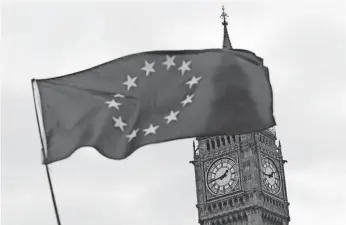  ?? DANIEL LEAL-OLIVAS, AFP/GETTY IMAGES ?? A European Union flag flies in Parliament Square after Prime Minister Theresa May announced Article 50 of the Lisbon Treaty had been triggered, formally starting Britain’s exit from the EU.