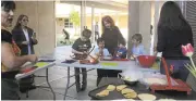  ?? KEVIN KELLY/DAILY NEWS ?? Zaida Soriano, far left, owner and chef of Oaxacan Kitchen Markets in San Jose, helps students and their parents make tortillas from scratch at Encinal School.