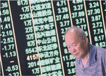  ??  ?? A man walks past a digital display in Hangzhou, China. Due to the increase in tariffs on $200 billion of US exports, the Shanghai and Shenzhen stock markets fell sharply yesterday, and were down more than 2 percent.