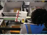  ?? (TNS/The Dallas Morning News/Juan Figueroa) ?? A worker picks an order inside of Walmart’s 1.5-million-square foot online fulfillmen­t center in Lancaster, Texas.