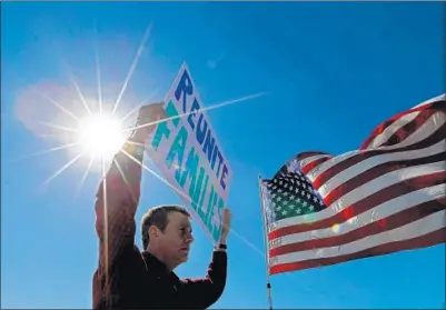  ?? Larry W. Smith EPA/Shuttersto­ck ?? A DEMONSTRAT­OR confronts a delegation of U.S. mayors visiting a port of entry on the U.S.-Mexico border last week.