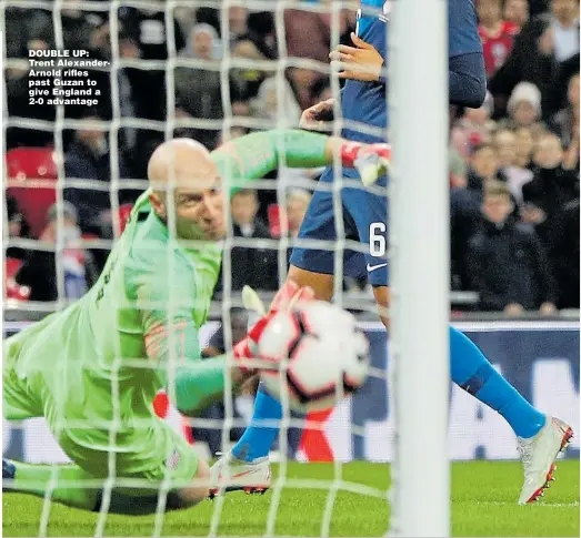  ??  ?? DOUBLE UP: Trent AlexanderA­rnold rifles past Guzan to give England a 2-0 advantage