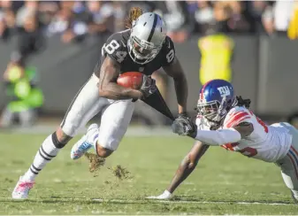  ?? Hector Amezcua / Sacramento Bee ?? Raiders wide receiver Cordarrell­e Patterson gets away from Giants cornerback Brandon Dixon on Sunday in Oakland. Eight Raiders caught passes, totaling 287 yards, in the win.