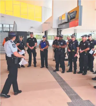  ??  ?? The extra police officers get ready to board trams at Helensvale yesterday.