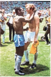  ?? GETTY IMAGES ?? The famous photograph of Pele and Bobby Moore swapping shirts at the end was a proof of the mutual respect between the two sides.