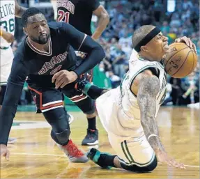  ?? Michael Dwyer Associated Press ?? ISAIAH THOMAS of Boston falls after being fouled by Chicago’s Dwayne Wade during the fourth quarter. Thomas led the Celtics with 33 points.