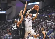  ?? Jessica Hill / Associated Press ?? UConn’s James Bouknight shoots over Central Florida’s Darin Green Jr, left, and Frank Bertz, center, in the first half on Wednesday.