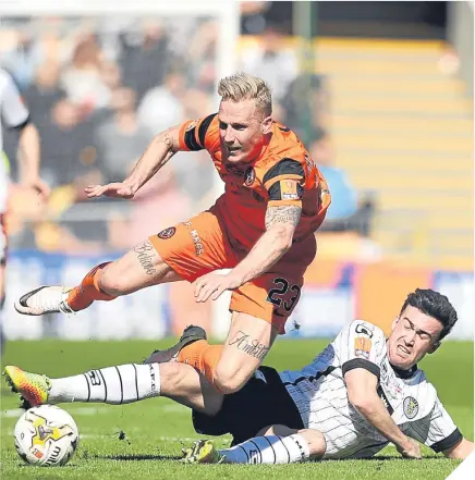  ??  ?? St Mirren’s Stevie Mallan slides in to win the ball from United’s Nick van der Velden.