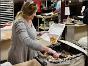  ?? ?? Volunteers at St. Mary’s served up deliciousl­y crispy fried fish, baked potatoes, rolls, coleslaw, and had a variety of desserts to choose from as well
Photo by Emily Schwan