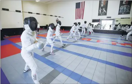  ?? PATRICK TEHAN/ STAFF ?? Participan­ts practice Friday during a fencing camp at the Academy of Fencing Masters in Campbell. The USA Fencing Summer National Championsh­ips, with 4,000 fencers, started Saturday and will go through July 6 at the San Jose McEnery Convention Center.