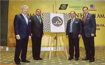  ??  ?? Minister in the Prime Minister’s Department Datuk Seri Jamil Khir Baharom (second from right) at the launching of Hibah Amanah in Kuala Lumpur yesterday. With him are Deputy Minister in the Prime Minister’s Department Dr Asyraf Wajdi Dusuki (right),...