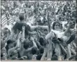  ?? DAN CHIDESTER — DAILY FREEMAN FILE ?? Festival-goers crowd surf during the Woodstock ‘94 concert at Winston Farm in Saugerties, N.Y., in August 1994.