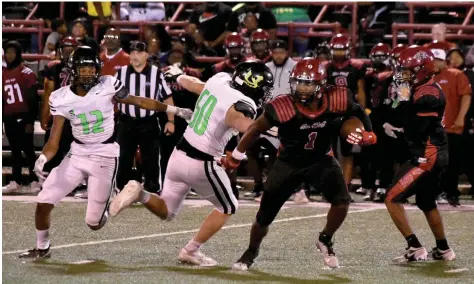  ?? (Pine Bluff Commercial/ I.C. Murrell) ?? Pine Bluff wide receiver Austyn Dendy (1) escapes a tackle by Mills defensive tackle Haiden Moreland (50) in the second quarter Friday at Jordan Stadium.