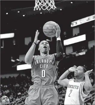  ?? Associated press ?? Oklahoma City Thunder guard Russell Westbrook drives to the basket past Houston Rockets forward Marcus Morris during the first half Saturday in Houston.