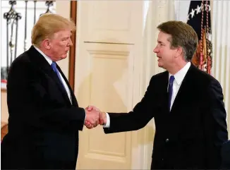  ?? MARK WILSON/GETTY IMAGES ?? President Donald Trump shakes hands Monday with his Supreme Court pick, Judge Brett Kavanaugh, at the White House.
