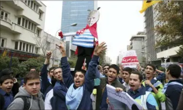  ?? VAHID SALEMI — THE ASSOCIATED PRESS FILE ?? FILE- In this file photo, Iranian schoolboys chant slogan while holding an effigy of U.S. President Donald Trump in an annual gathering in front of the former U.S. Embassy marking the anniversar­y of its 1979 takeover in Tehran, Iran. President Donald...