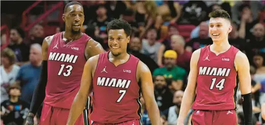  ?? MARTA LAVANDIER/AP ?? With Bam Adebayo, left, and Tyler Herro, right, the Heat’s future appears to be secure. But how does that impact win-now older players, such as Kyle Lowry, middle.