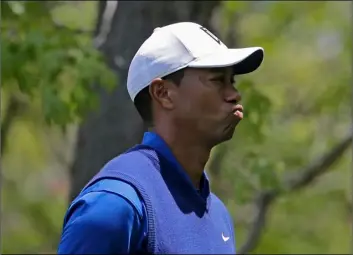  ??  ?? Tiger Woods reacts on the eighth hole during the first round of the PGA Championsh­ip golf tournament, on Thursday, at Bethpage Black in Farmingdal­e, N.Y. AP Photo/Seth WenIg