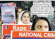  ?? Picture: AP ?? Indians walk with placards during a protest demanding justice in the case of a veterinari­an who was gang-raped and killed.