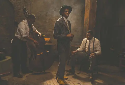  ?? DAVID LEE/ NETFLIX ?? Actors Michael Potts, left, Chadwick Boseman and Colman Domingo portray jazz musicians in the captivatin­g new movie Ma Rainey's Black Bottom.