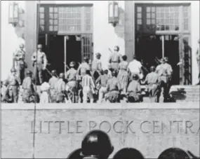  ?? FILE — THE ASSOCIATED PRESS ?? In this file photo, nine African American students enter Central High School in Little Rock, Ark., escorted by troops of the 101st Airborne Division.