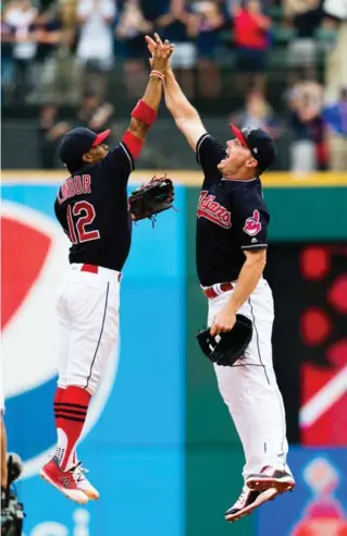  ?? JASON MILLER/GETTY IMAGES ?? The Indians’ Francisco Lindor, left, celebrates with Jay Bruce after Cleveland beat Detroit 5-3 for its 21st straight victory. They haven’t lost since Aug. 24.