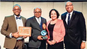  ??  ?? Tourism Minister Edmund Bartlett (second left) holds his Worldwide Tourism Minister of the Year Award by the prestigiou­s Pacific Area Travel Writers Associatio­n following its presentati­on before an internatio­nal audience at the ITB Global Tourism Trade show in Berlin, Germany. He is flanked by Donovan White, director of tourism (left); Jamaica chargé d’affaires for Germany, Keisha Kal Witter, and senior adviser/strategist to the tourism minister, Delano Seiveright.