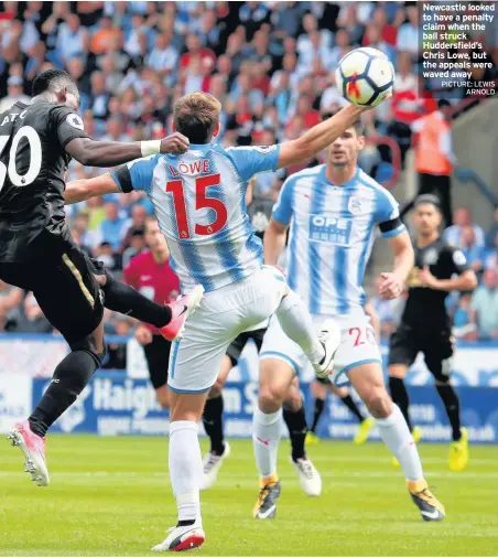  ??  ?? Newcastle looked to have a penalty claim when the ball struck Huddersfie­ld’s Chris Lowe, but the appeals were waved away