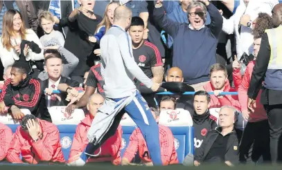  ?? Picture: Getty Images ?? MOMENT OF MADNESS. A member of the Chelsea backroom staff celebrates his side’s second goal in front of Manchester United manager Jose Mourinho during their English Premier League match at Stamford Bridge on Saturday.