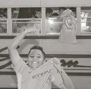  ?? Yi-Chin Lee / Houston Chronicle ?? Manchester City soccer camp kids, from Spring Spirit, are excited for their team as their bus arrives at NRG Stadium before Thursday’s game.