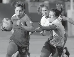  ??  ?? Canada’s Ghislaine Landry, left, runs past France players during the women’s Rugby Sevens World Cup in San Francisco, on Friday.