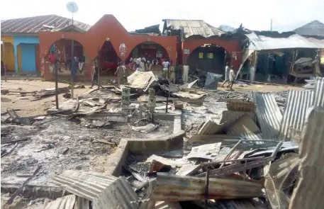  ?? PHOTO: Adam Umar ?? Burnt shops after the content of a crashed petrol tanker caught fire at Tafa, along the Abuja-Kaduna Expressway yesterday