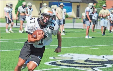  ?? File ?? C.J. Hawkins, a sophomore wide receiver for the Calhoun Yellow Jackets, runs up field following a catch during practice in preparatio­n for the football season that will see Calhoun compete in the quarterfin­als of the GHSA playoffs.