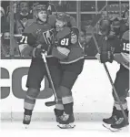  ?? ASHLEY LANDIS/AP ?? Golden Knights center Jonathan Marchessau­lt, center, celebrates with center William Karlsson, left, after scoring against the Kings on Tuesday.