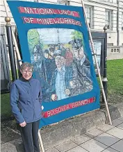  ?? PHOTO COURTESY KATHRYN WEBLEY ?? Kathryn Webley with the banner she hadn’t seen for 40 years.