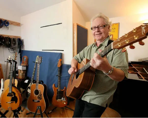  ??  ?? GUITAR PICKER: Paul Brady with a few of his favourite instrument­s in his home recording studio near Stepaside. Photo: Frank McGrath