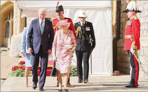  ??  ?? Britain’s Queen Elizabeth II (centre), walks with US President Joe Biden during his visit to Windsor Castle, near London, June 13. (AP)