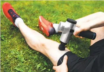  ?? GETTY IMAGES ?? Using a massage gun on oneself provides an instant feedback loop that helps prevent pain and injury.