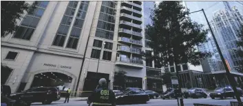  ?? AP PHOTO/BRYNN ANDERSON ?? A police officer stands near the entrance of a residentia­l building, on Wednesday in Atlanta.