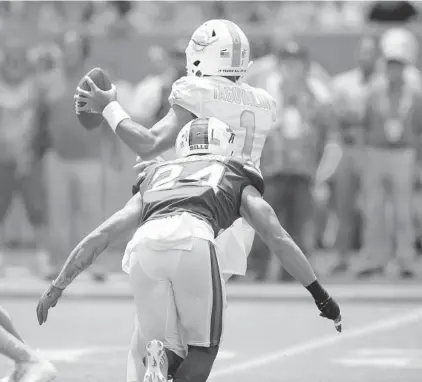  ?? JOHN MCCALL/SOUTH FLORIDA SUN SENTINEL ?? Dolphins quarterbac­k Tua Tagovailoa is sacked by Bills cornerback Taron Johnson during the first quarter Sunday at Hard Rock Stadium in Miami Gardens.