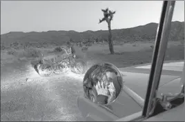  ??  ?? ‘(COUPLE) TODD BLUBAUGH & NICOLA COLLIE / TWENTYNINE PALMS’ Bowen Smith saw his friends Todd and Nicola kiss in the side mirror of his truck. He found this so beautiful he had them re-create the moment for a portrait.