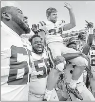  ?? AP/MATTHEW HINTON ?? LSU place-kicker Connor Culp is carried off the field on the shoulders of teammates Jibrail Abdul-Aziz (58) and Cameron Gable after kicking two field goals in the final 2:36 to give the Tigers a 27-23 victory over No. 10 Auburn in Baton Rouge.