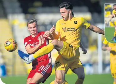  ??  ?? Aberdeen’s Jon Gallagher loses out to Livingston’s Ricki Lamie