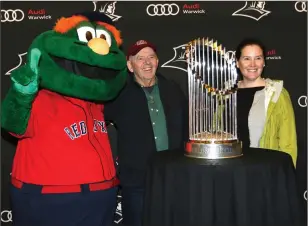  ?? Photo by Louriann Mardo-Zayat / lmzartwork­s.com ?? Two fans pose with the Red Sox mascot Wally The Green Monster and the 2018 World Series trophy prior to Sunday’s Providence College-Central Connecticu­t game at the Dunkin’ Donuts Center.