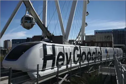  ?? ALEX WONG, GETTY IMAGES ?? A Las Vegas monorail car with a Google ad passes in front of the High Roller Observatio­n Wheel prior to the opening of CES 2018 on Sunday.