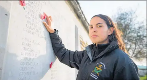  ??  ?? Leading Aircraftma­n Ellie Mullin pays tribute to her great great-uncles Claude and James Furze at the New Zealand Memorial to the Missing in Caterpilla­r Valley cemetery in Longueval.