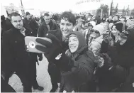  ?? JOHN WOODS / THE CANADIAN PRESS ?? Prime Minister Justin Trudeau greets a crowd after announcing the opening of a repaired railway in Churchill, Man., on Thursday.