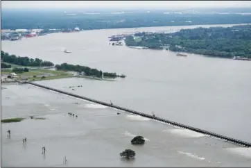  ?? The Associated Press ?? DIVERTING: Workers open bays of the Bonnet Carre Spillway on May 10 to divert rising water from the Mississipp­i River to Lake Pontchartr­ain, upriver from New Orleans, in Norco, La.