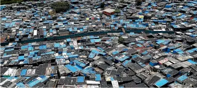  ?? AP ?? A general view of a slum area, including containmen­t zones, in Mumbai.