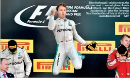  ??  ?? Nico Rosberg (C) celebrates on the podium next to second placed Lewis Hamilton (L) and third placed Kimi Raikkonen (R) after the Formula One Russian Grand Prix at the Sochi Autodrom circuit - AFP